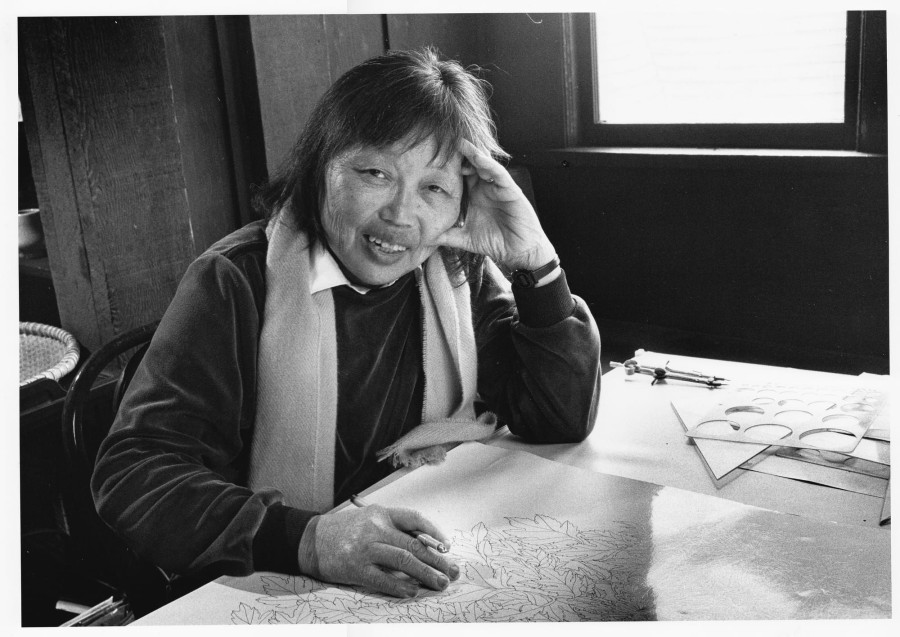 Ruth Asawa drawing at a table in the living room of her Noe Valley home, San Francisco, California, 1985 (photo Paul Glines; artwork © 2026 Ruth Asawa Lanier, Inc., courtesy David Zwirner)